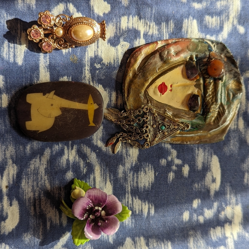 Assorted vintage handmade artisan pins.